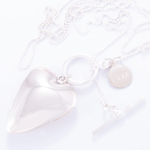 Our Long Fine Sterling Silver Ball Chain Large Puffed Heart Small Love Disc Fob Necklace. Shown here, beautifully hand-made and stamped in 925 sterling. In short, this beautiful piece is full of love and full of style. The perfect self-indulgent addition to your personal jewelry collection. Or as a gift for someone very special.