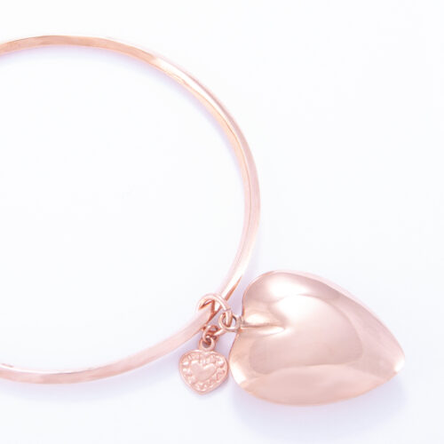 Our Rose Gold Large Puffed Heart Bangle. Shown here, plated over hand-made 925 sterling with a large puffed heart. As well as, with a small heart. It's a truly unique and stunning piece. In short, the ideal gift idea, with double the love. Or as a self-indulgent addition to your own jewelry collection.