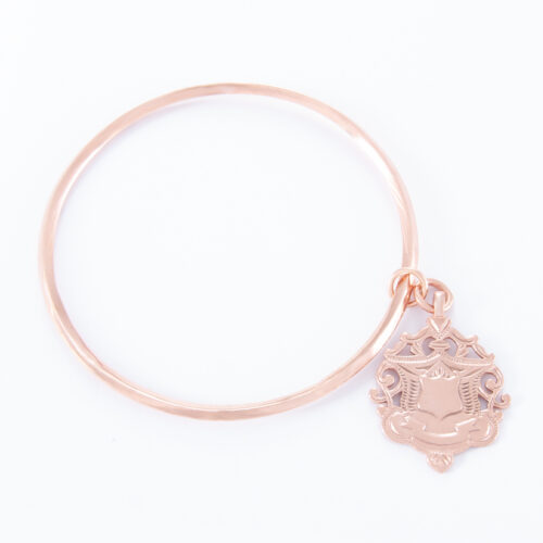 Our Rose Gold Large Shield Bangle. Shown here, plated in pink gold over a 925 sterling silver large shield. It's a truly unique and stunning piece. In short, the ideal gift idea for someone extra special. Or as a self-indulgent purchase to add to your own personal jewelry collection.