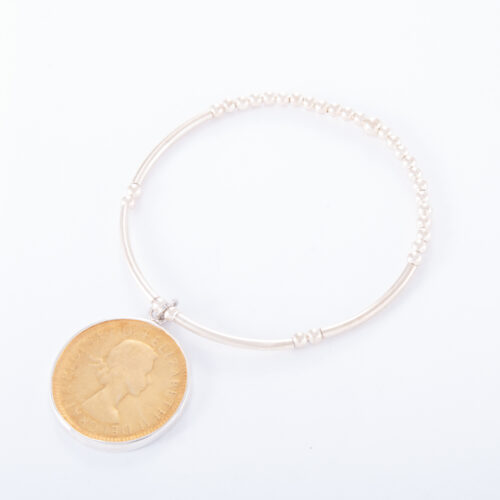 Our Sterling Silver Ball Bar 2 Tone Half Penny Bracelet. Shown here, in hand-made 925 sterling with a gold plated coin as well as a sterling rim. In short, this beautiful piece is timeless. The perfect self-indulgent addition to any personal jewelry collection. Or as the ideal gift for someone special.