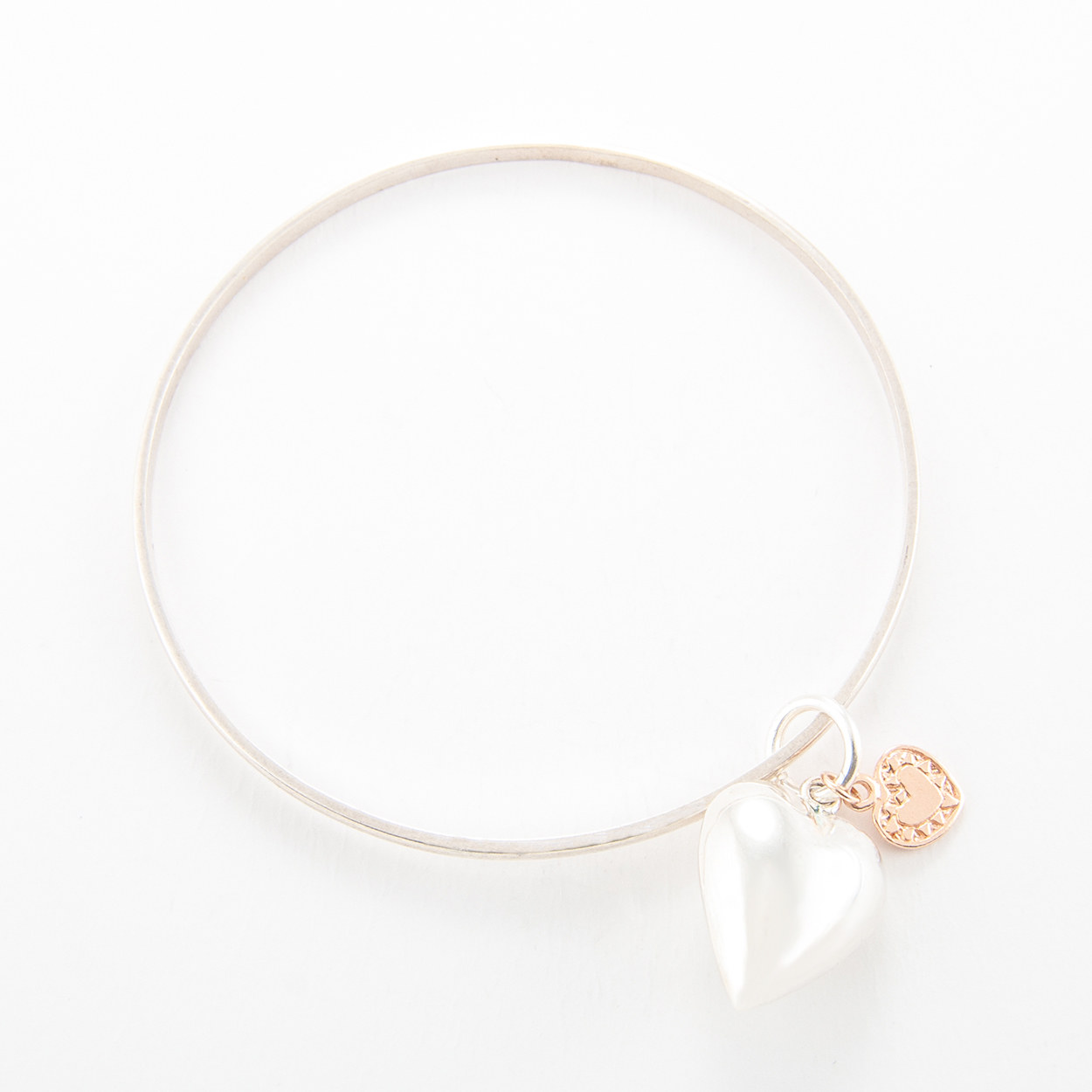 Sterling Silver Bangle with large puffed heart and small rose gold flat heart.