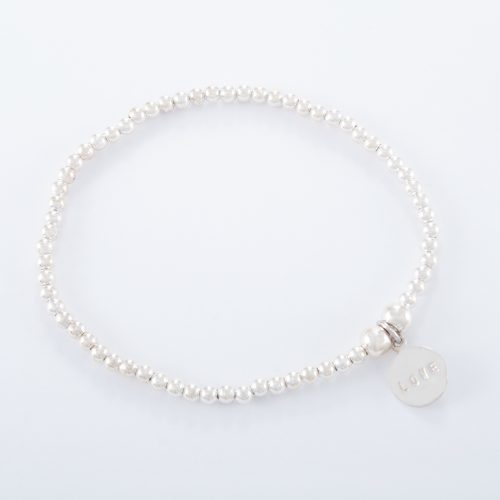 Our Sterling Silver Small Love Disc Ball Bracelet. Shown here, with a stunning 925 sterling charm stamped with LOVE. In short, this is a beautiful piece that's sure to hit the mark. The ideal self indulgent purchase to add to your own jewellery collection. Or as the perfect gift for somebody extra special.