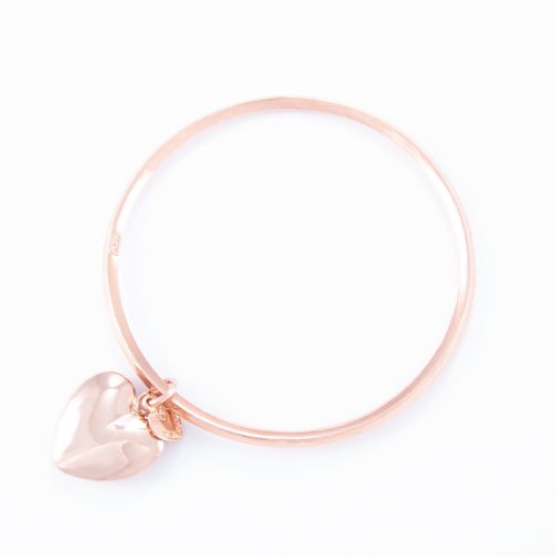 Our Rose Gold Small Puffed Heart Bangle. Shown here, with pink gold plated over hand-made 925 sterling silver. As well as, with a small flat heart. It’s a truly stunning and unique piece. In short, it's the perfect gift idea, with twice the love. Or as a self-indulgent purchase to add to your own personal jewellery collection.