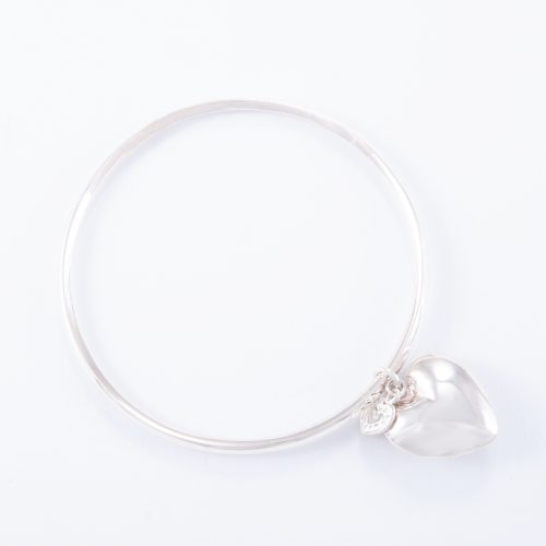 Our Sterling Silver Small Puffed Heart Bangle. Shown here, in hand-made 925 sterling, bevel-edged with a small puffed heart charm. As well as, with a small flat sterling heart.