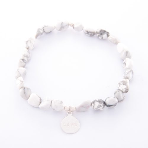 Our Howlite Bracelet with Sterling Silver Love Disc. Shown here, with a beautiful "LOVE" stamped, hand-made authentic 925 sterling charm. In short, this stunning piece is full of fun and style. It’s the ideal self-indulgent purchase to add to your own jewelry collection. Or makes the perfect gift for someone special.