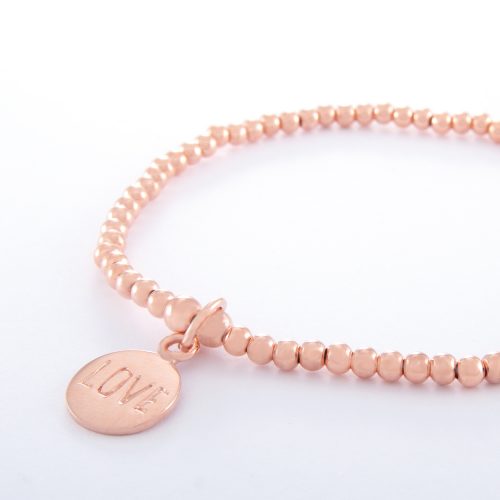 Our Rose Gold Ball Chain Bracelet and Love Disc. Shown here, beautifully handcrafted in pink gold over 925 sterling. As well as, with a stamped "Love" charm. There’s lots of love in this elegant, stunning piece. In short, it’s the perfect self-indulgent purchase to add to your own jewelry collection. Or as a unique gift idea for someone extra special.