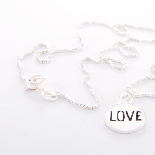 Our Sterling Silver Box Chain Necklace and Small Love disc. Shown here, handcrafted beautifully in 925 sterling. As well as with a small stamped charm. In short, this unique and elegant piece is sure to hit the mark. It’s the ideal gift for someone special. Or as the perfect self-indulgent purchase to add to any jewelry collection.