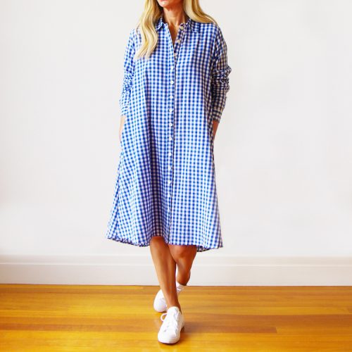 Our Millie Gingham Dress Shirt (Blue). Is absolutely beautiful. Shown here, in 100% pure cotton, a unique a-line shape, crisp collar, and button-up front. As well as comfy side pockets, cuffed sleeves, and medium-size blue and white check. What’s more, our amazing Millie comes in 3 sizes and offers a free-size relaxed fit. An XS for ladies 8-10, an S/M for ladies size 12-14, and an M/L for 14-16. In short, it’s the perfect gift idea for someone extra special. Or as the perfect self-indulgent purchase to add to your wardrobe.
