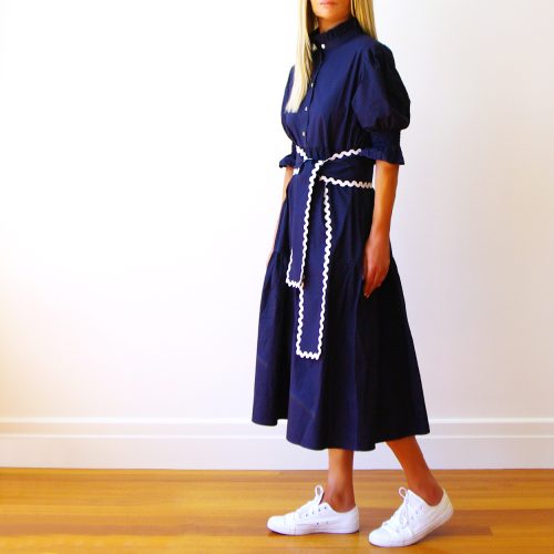 Lottie Navy Cotton Poplin Dress with Ric Rac Belt. (Side)